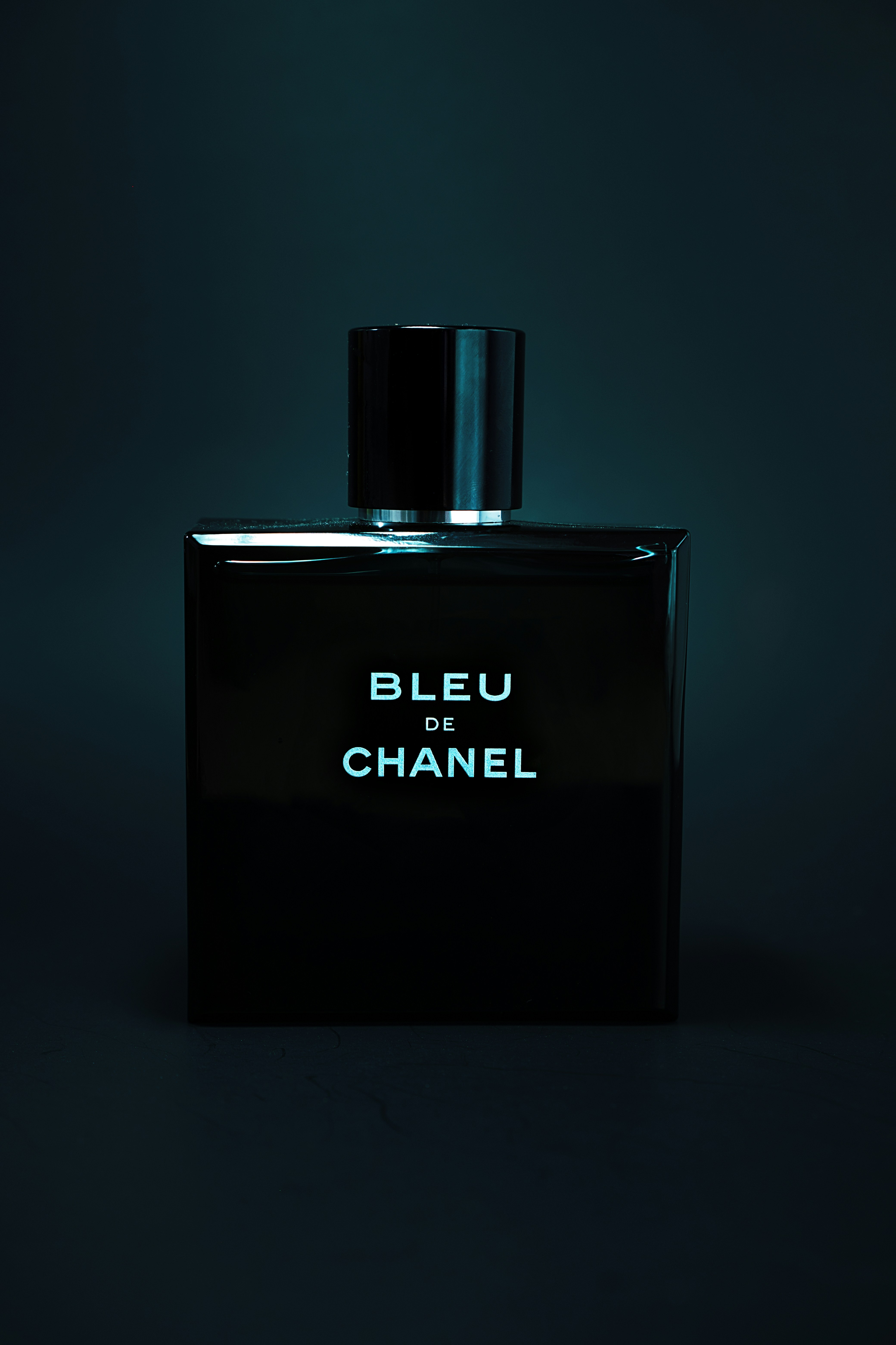 A black bottle with the words bleu de chanel on it