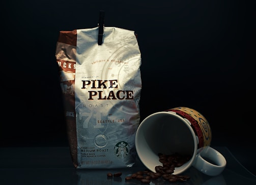 A bag of coffee next to a cup of coffee