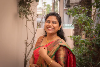 A woman in a red and green sari