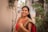 A woman in a red and green sari -