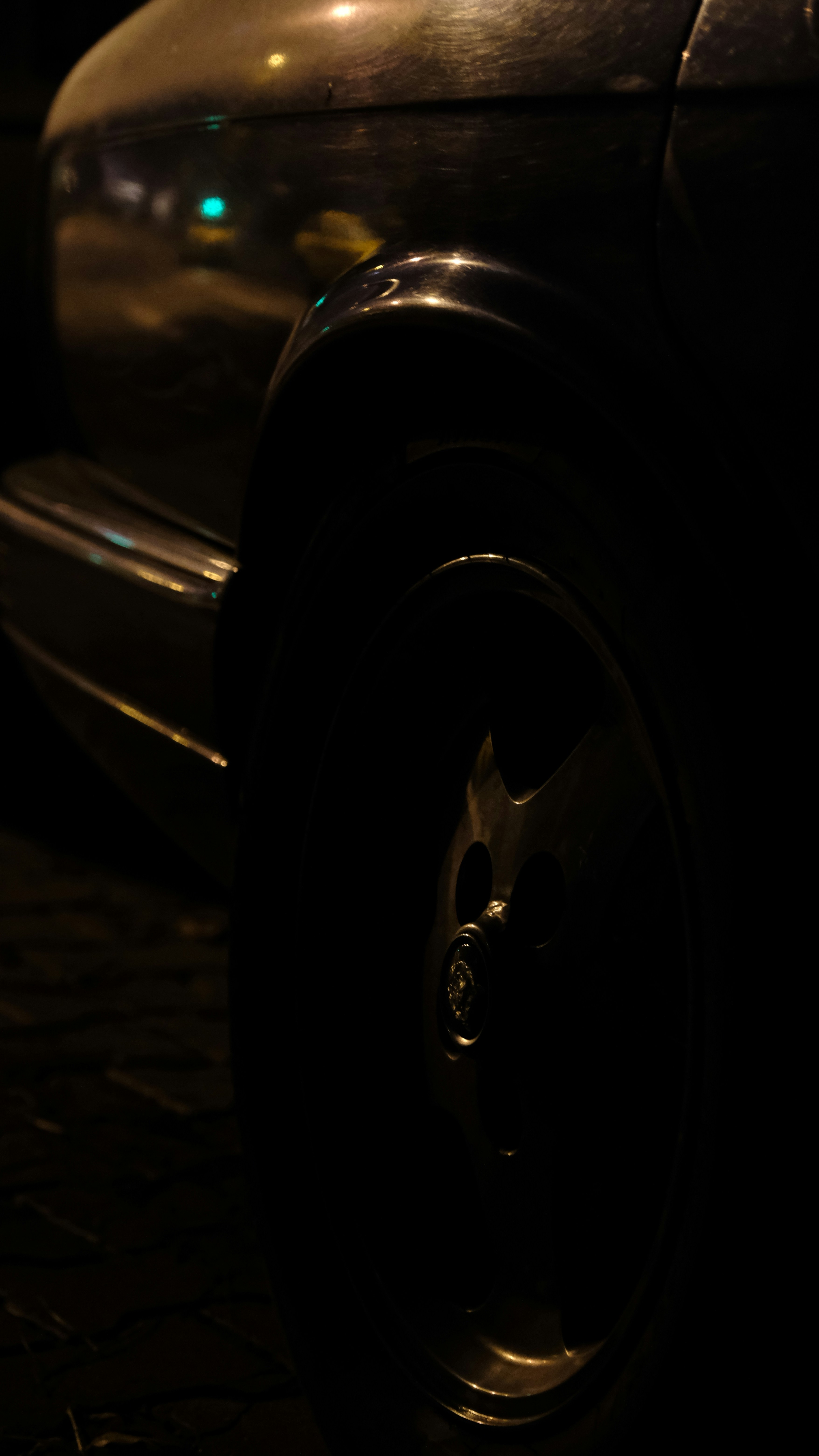 A close up of a parked car at night