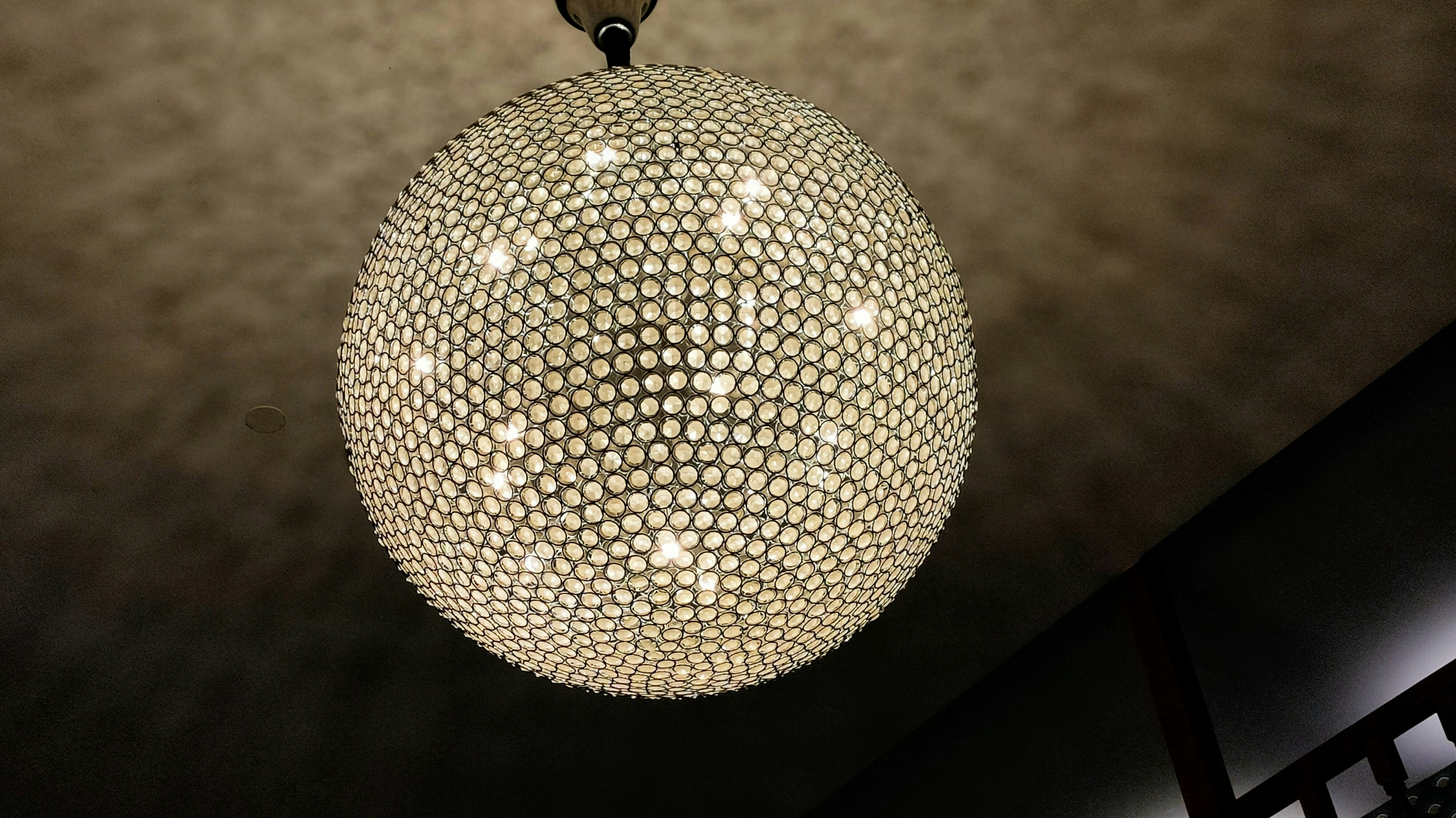 A chandelier hanging from a ceiling in a room