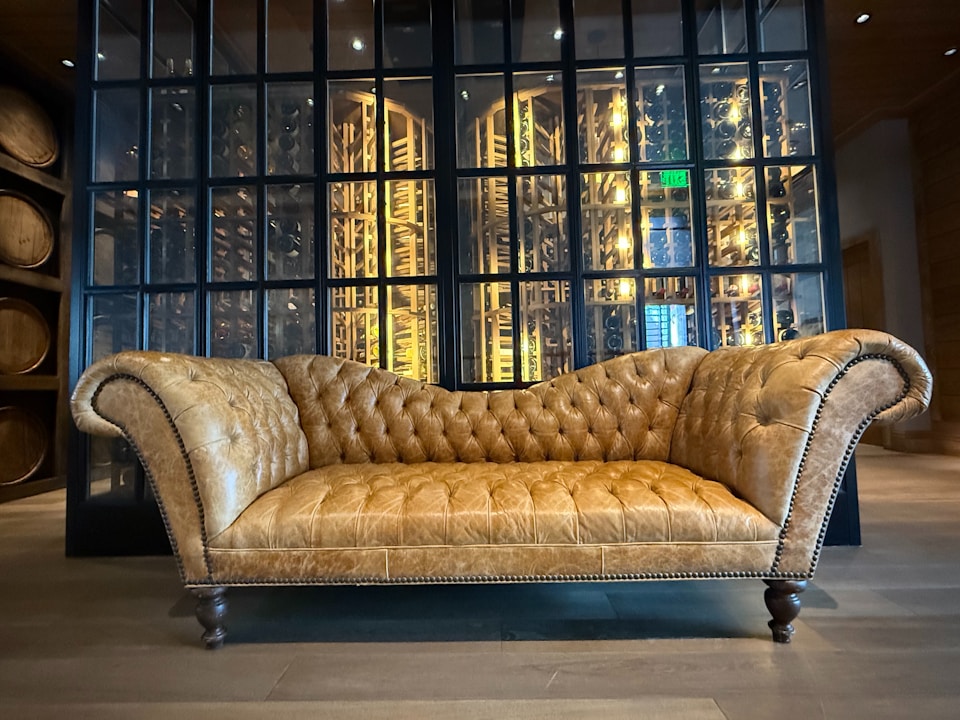 A couch sitting in front of a glass wall