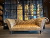 A couch sitting in front of a glass wall