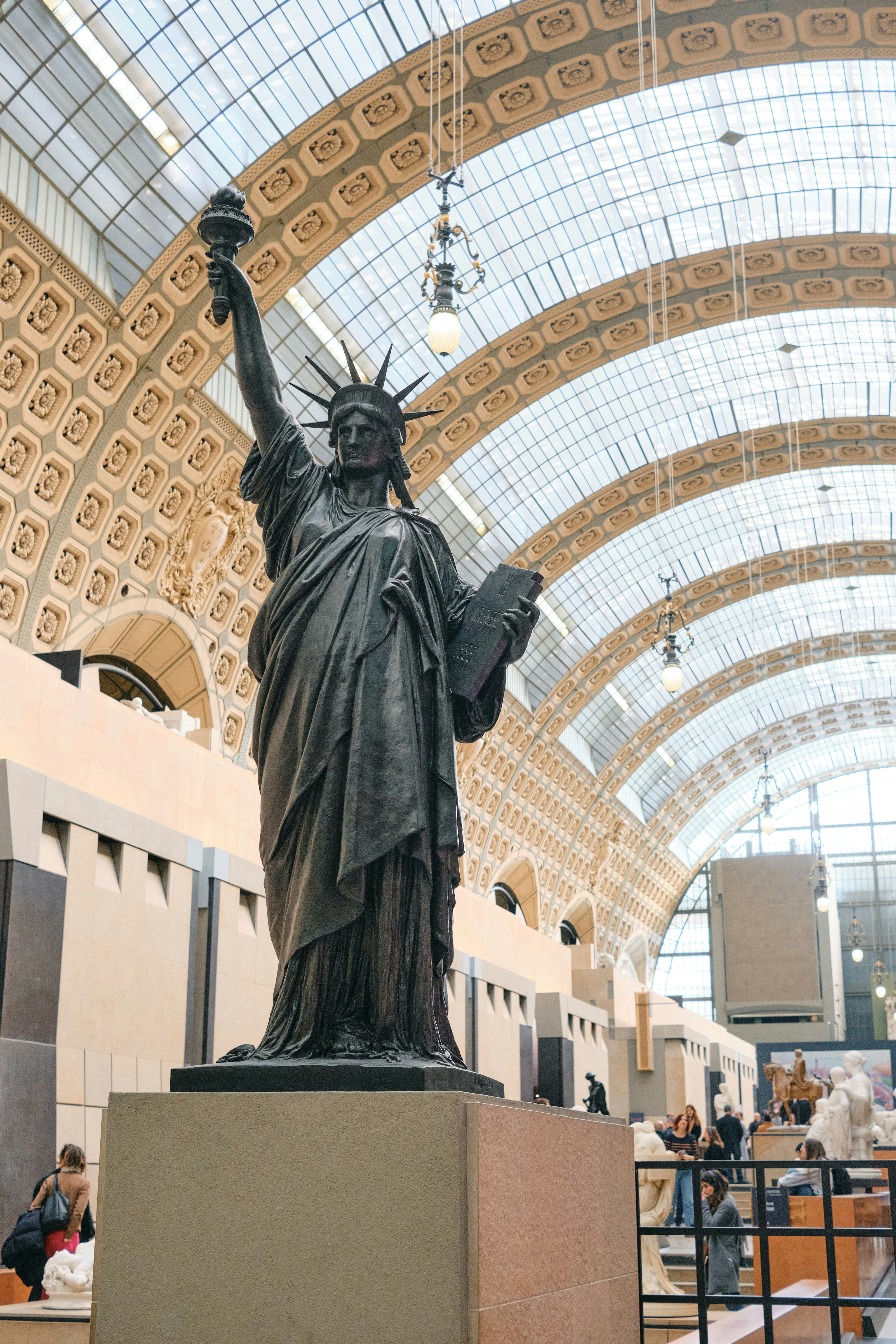 The statue of liberty is in the middle of a lobby