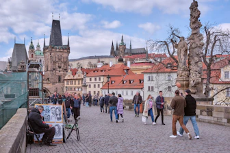 A group of people walking across a bridge