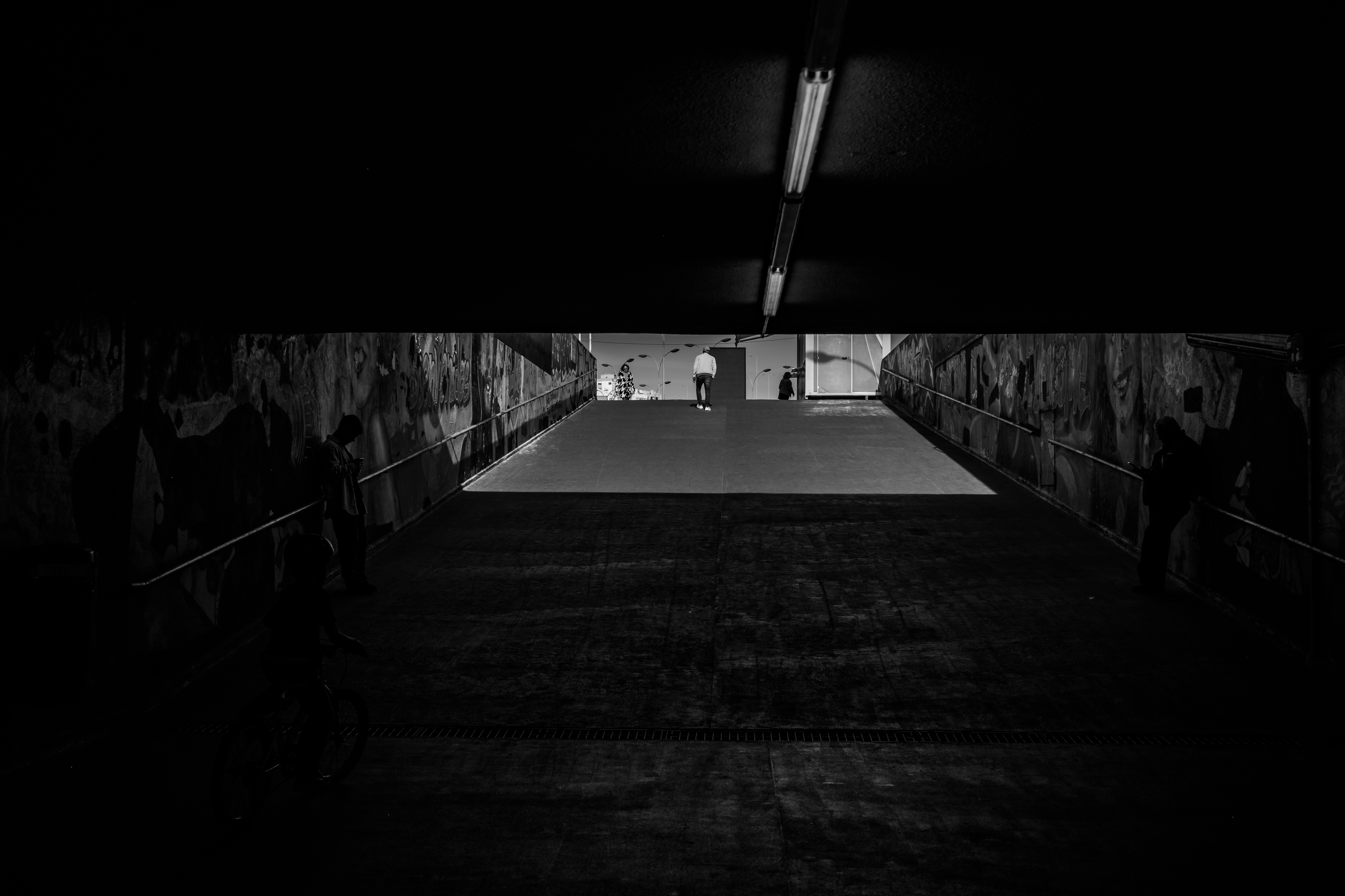 lone pedestrian under archways