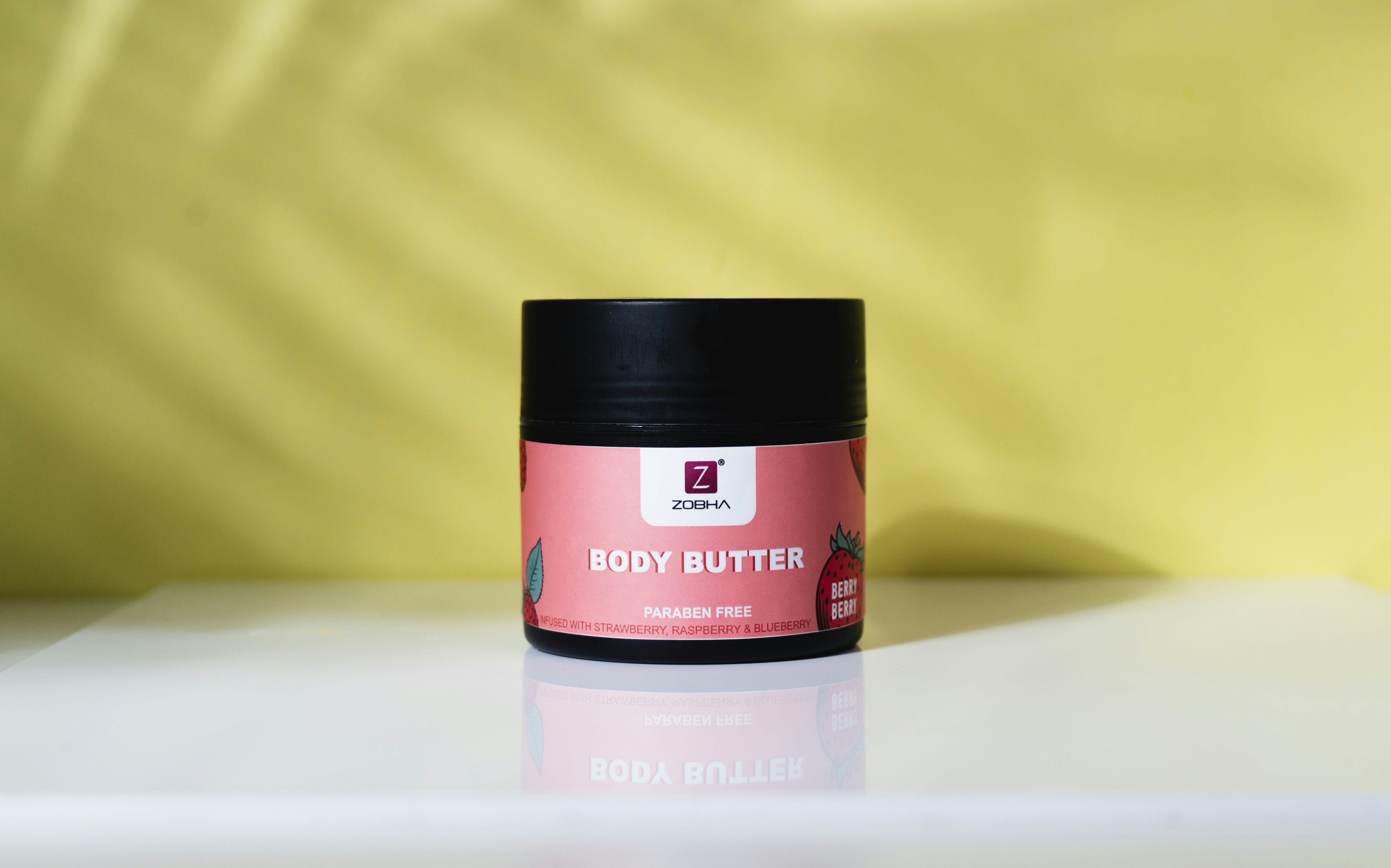 A jar of body butter sitting on a table