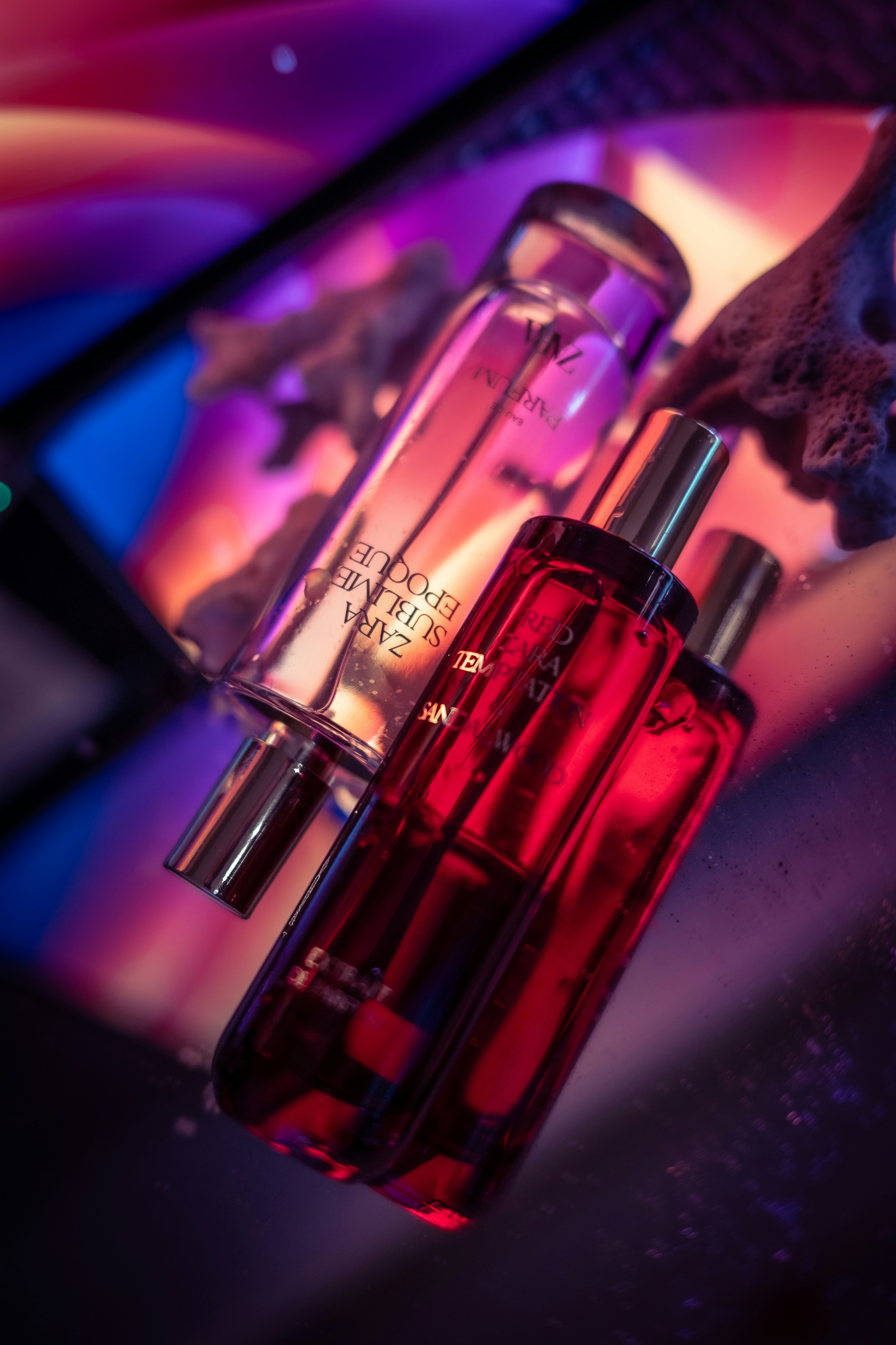 A couple of bottles of perfume sitting on top of a table
