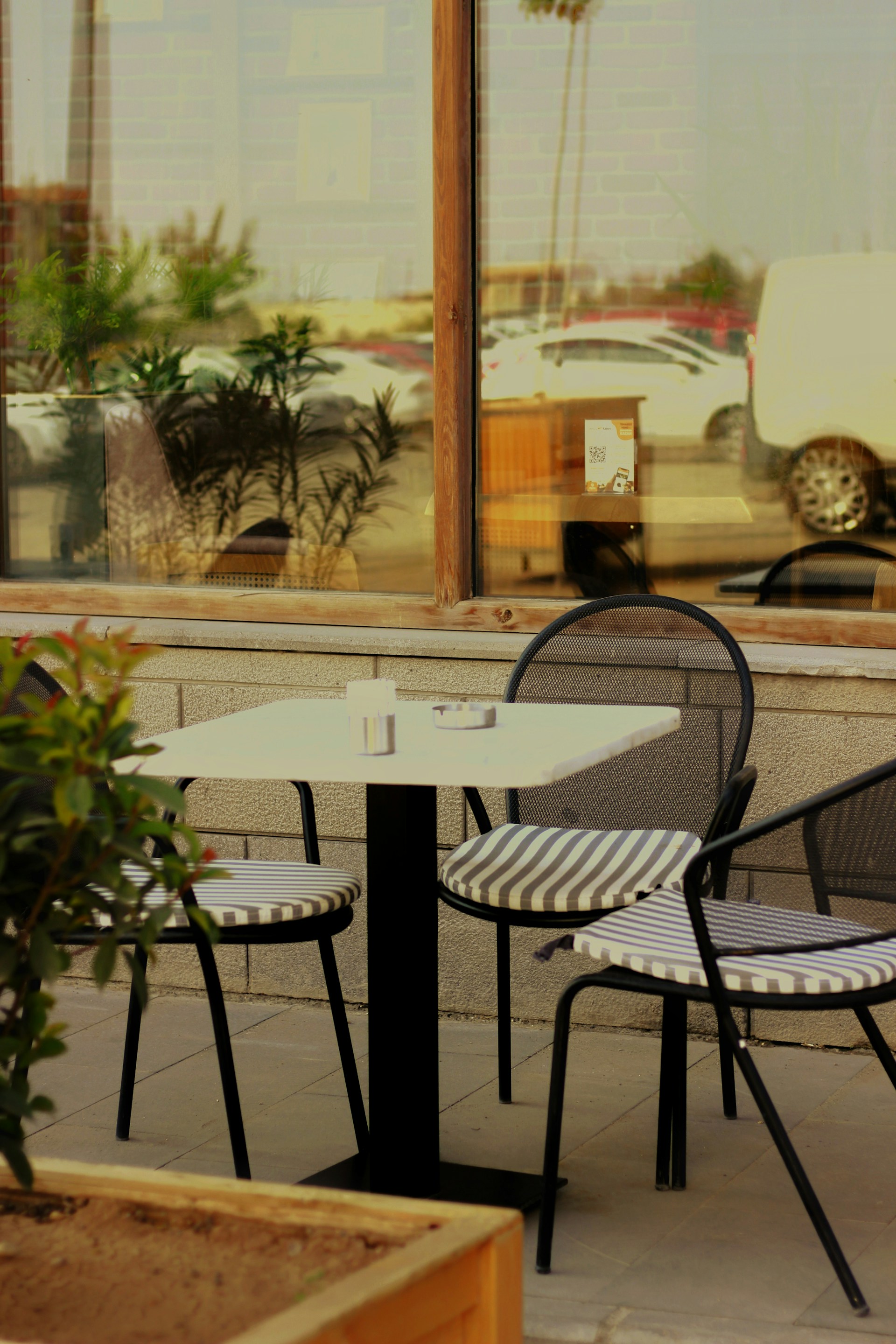 A couple of tables and chairs outside of a building