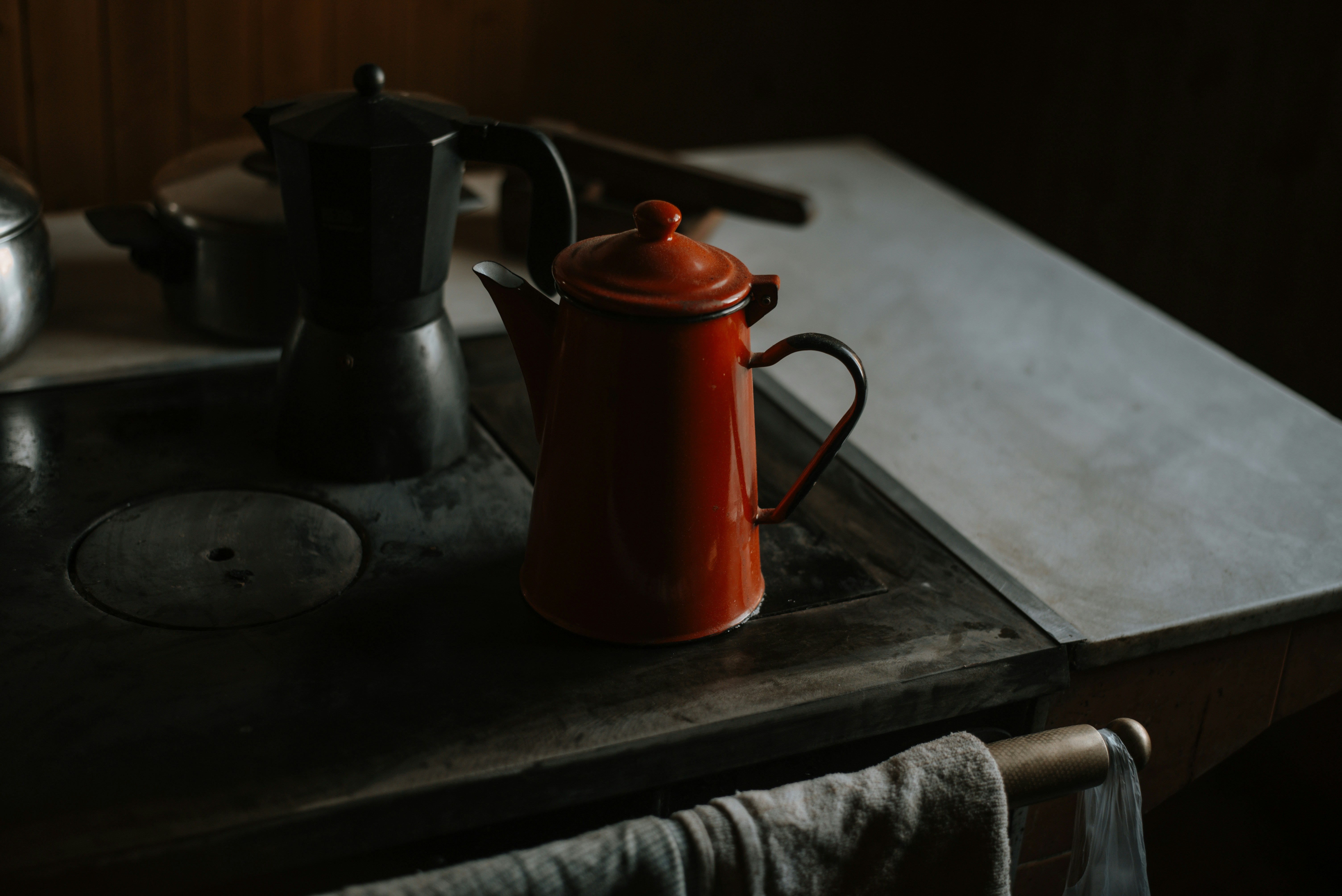 A tea pot sitting on top of a stove