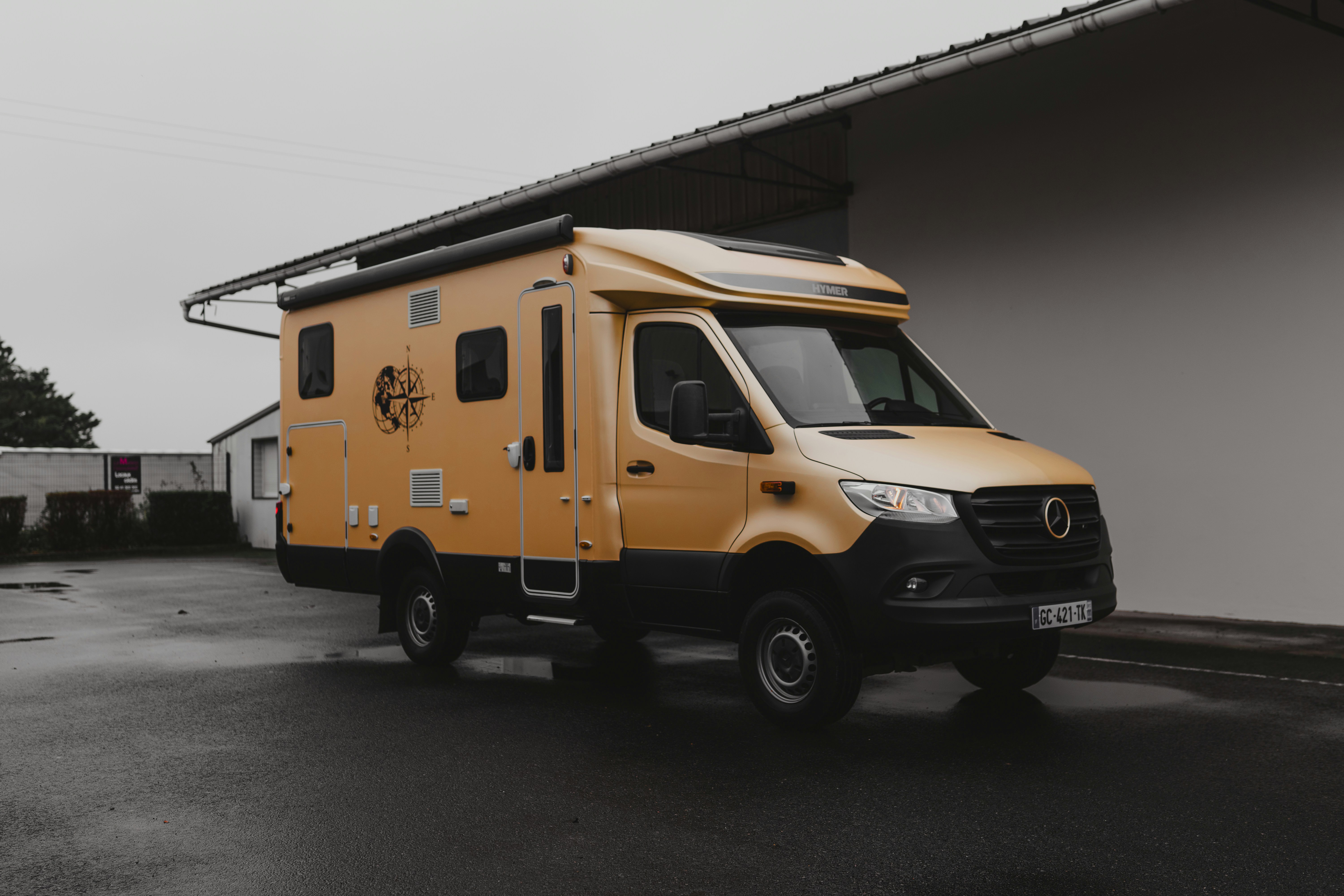 A yellow van parked in front of a building