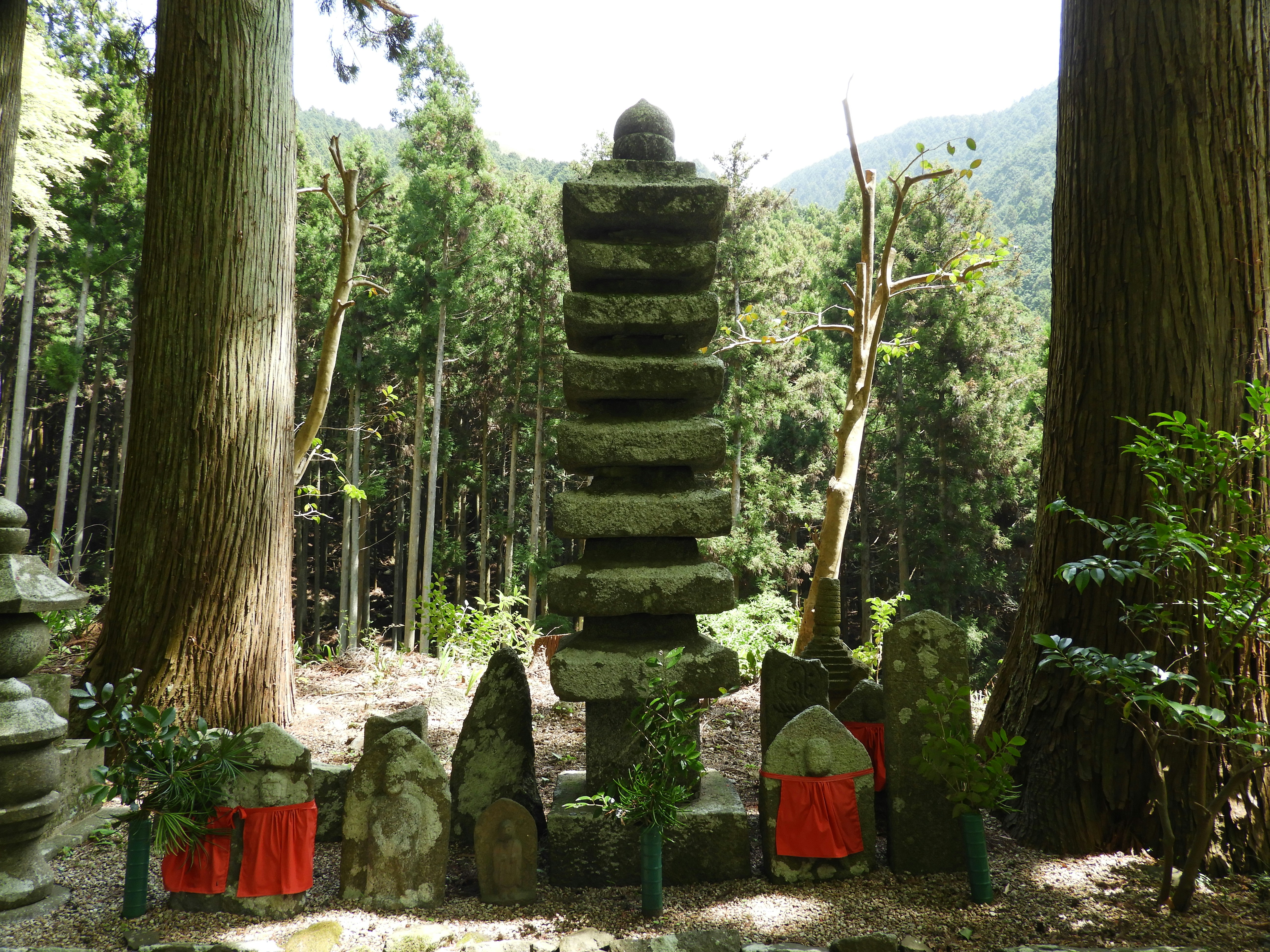 A stone tower in the middle of a forest