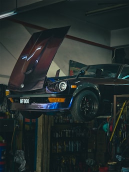 A car in a garage with the hood open