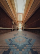 A long hallway with a tiled floor and a skylight