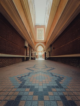 A long hallway with a tiled floor and a skylight