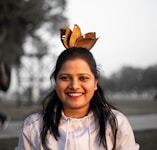 A woman in a white shirt is smiling