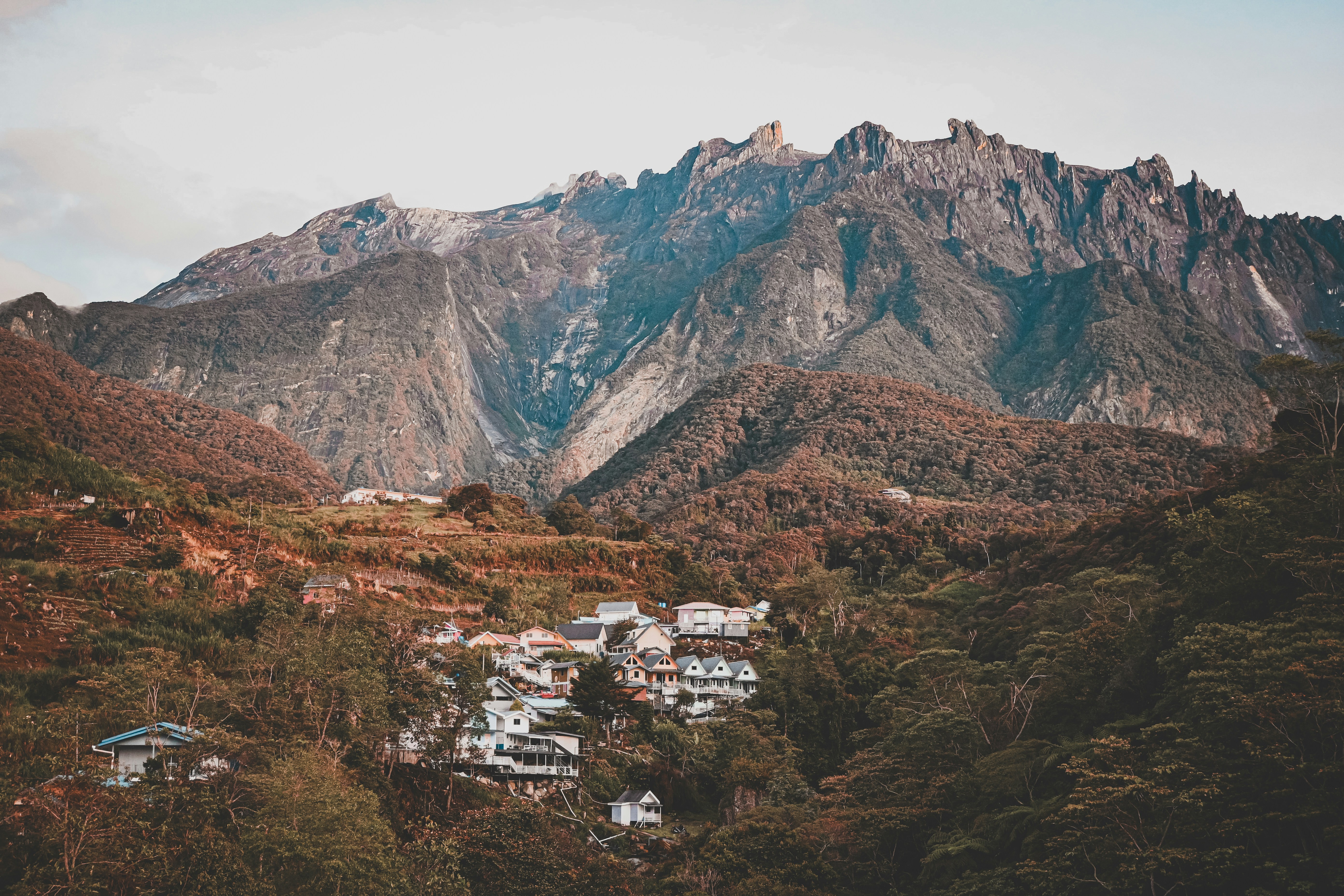 A view of a mountain range with houses in the foreground