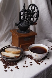 A table topped with a plate of food and a cup of coffee