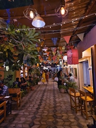 A restaurant filled with lots of people sitting at tables