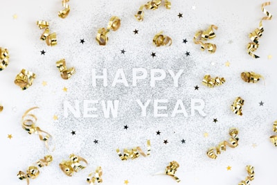 A happy new year card with gold bells and confetti