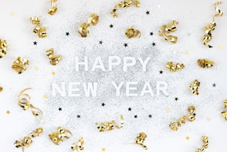 A happy new year card with gold bells and confetti