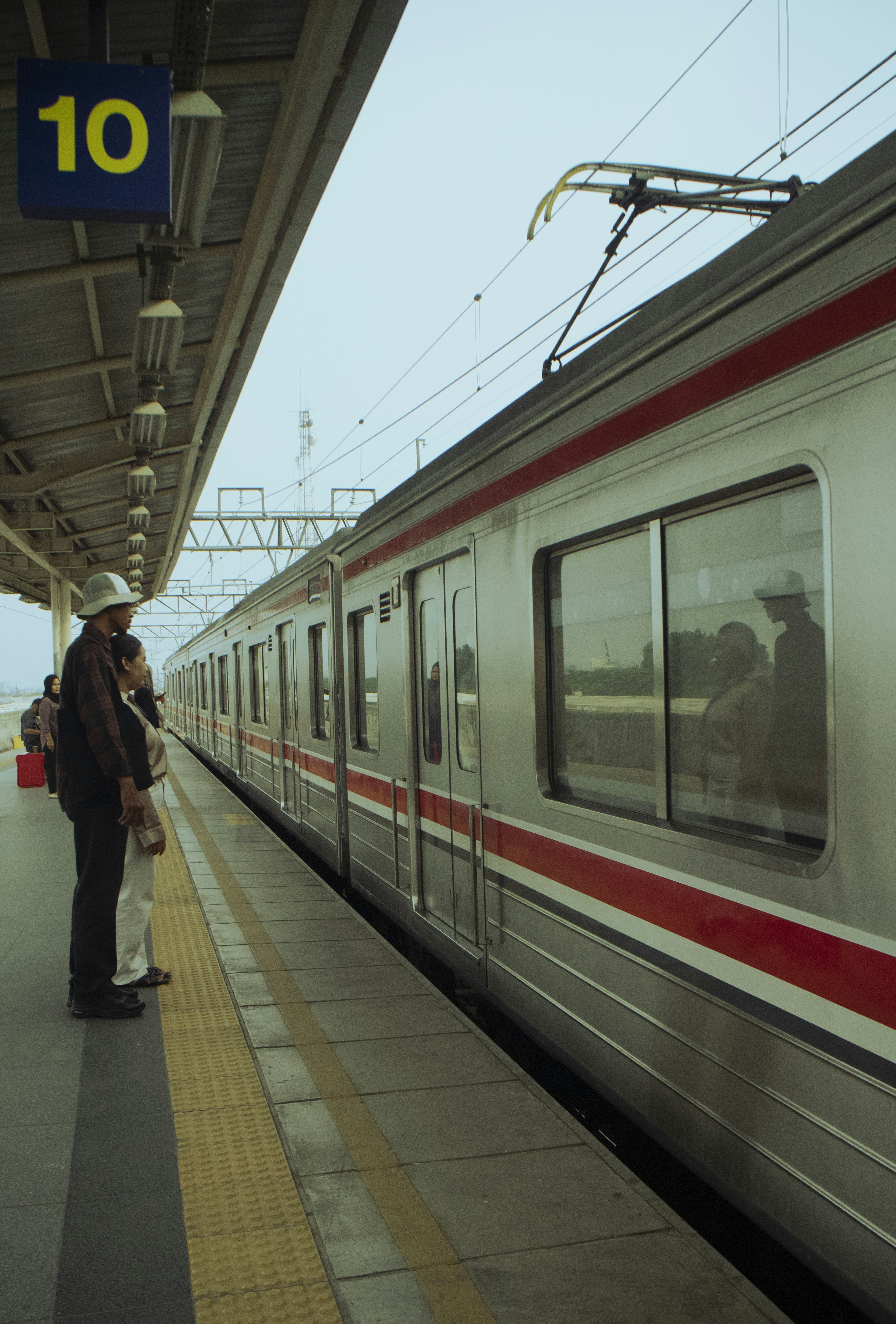 A train pulling into a train station next to a platform