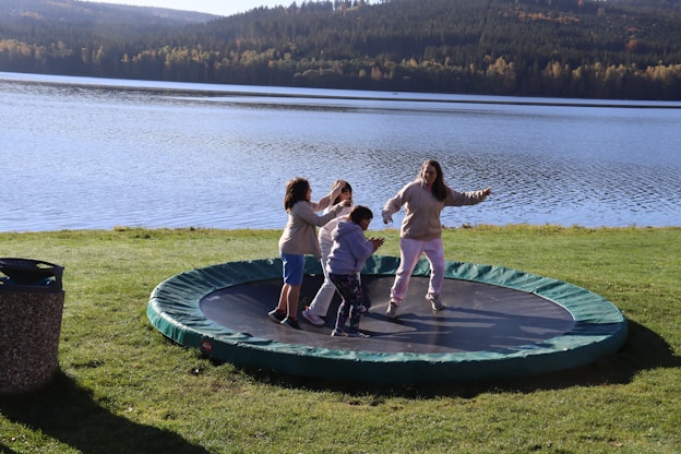 A group of people standing on top of a trampoline
