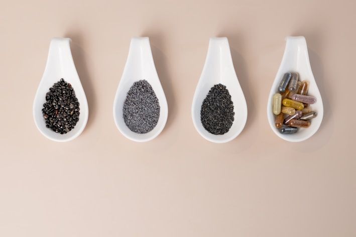 A row of spoons filled with different types of spices
