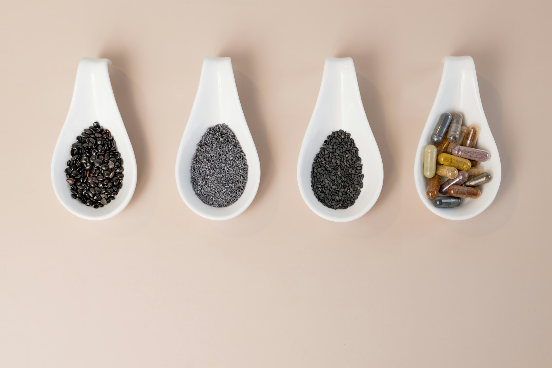 A row of spoons filled with different types of spices
