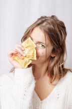 A woman holding a piece of food up to her face