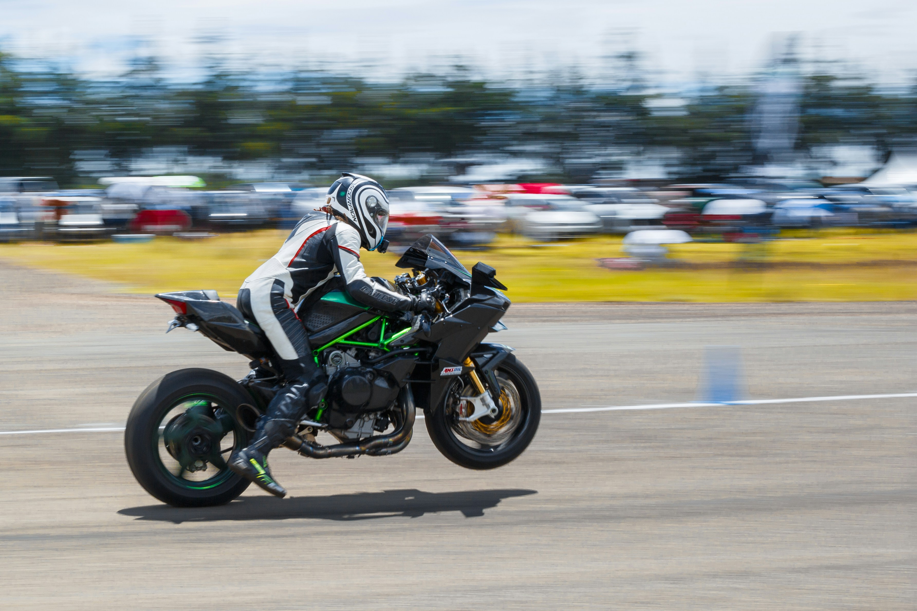 A man riding a motorcycle on top of a runway photo – Free Speedbike ...
