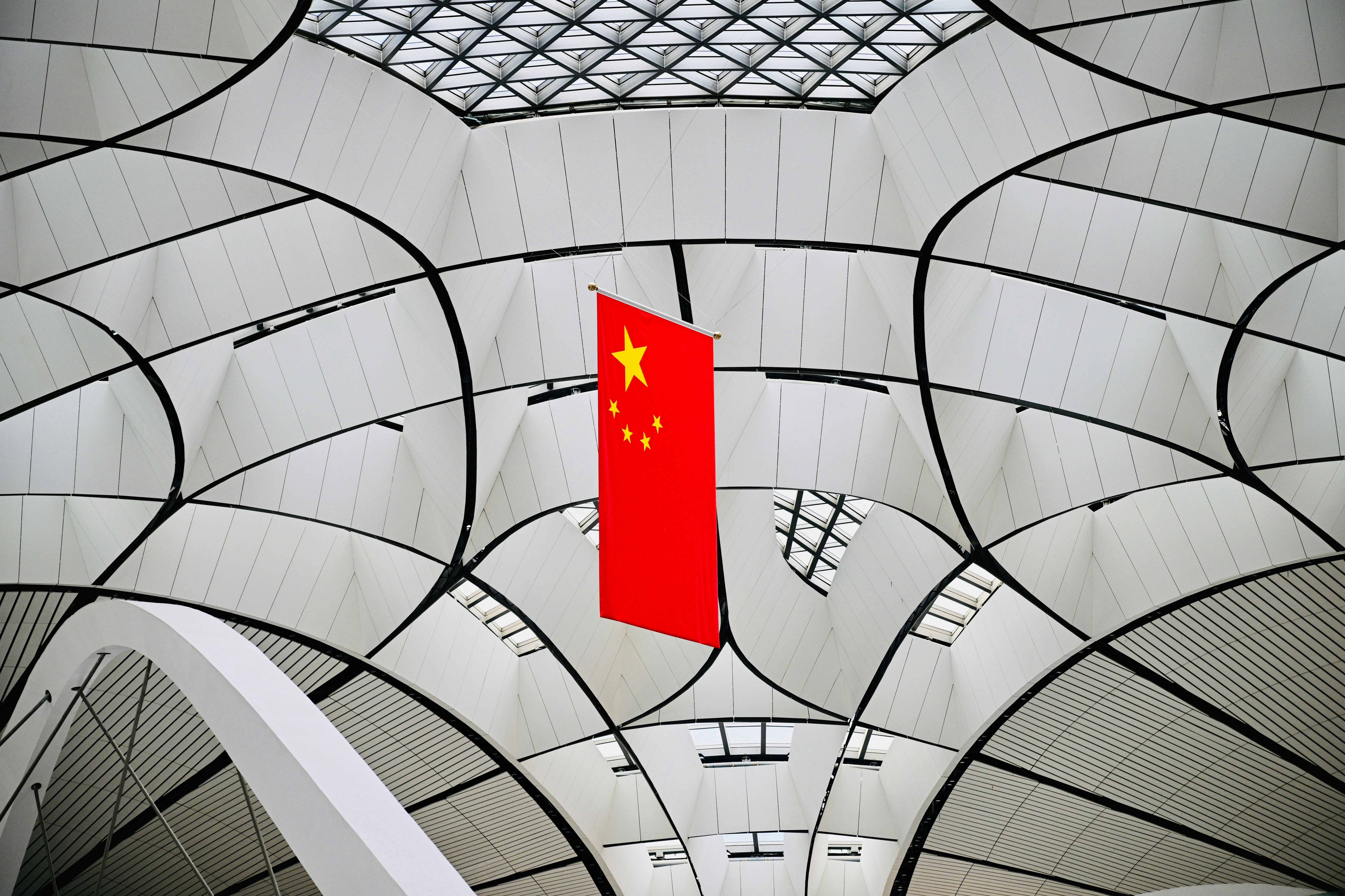 A red flag hanging from the ceiling of a building