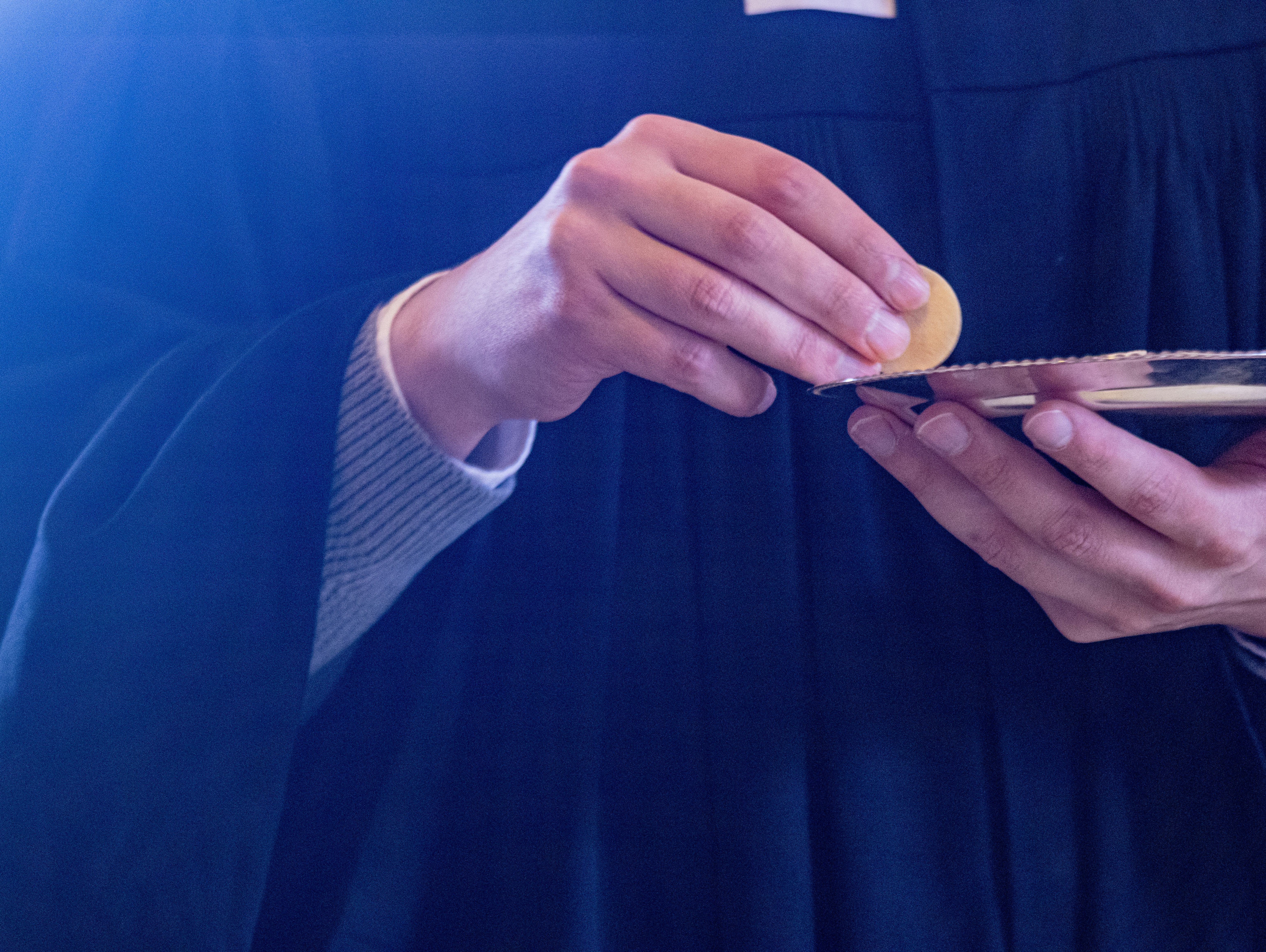 A person in a robe holding a cell phone