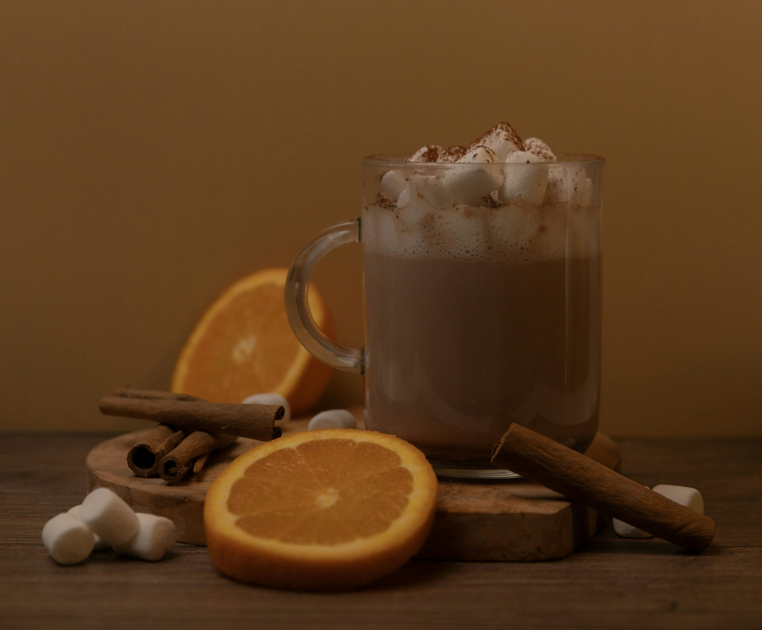 A cup of hot chocolate with cinnamon and an orange slice photo Free A cup of hot chocolate with cinnamon and an orange slice photo Free