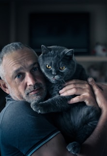 A man holding a cat in his arms