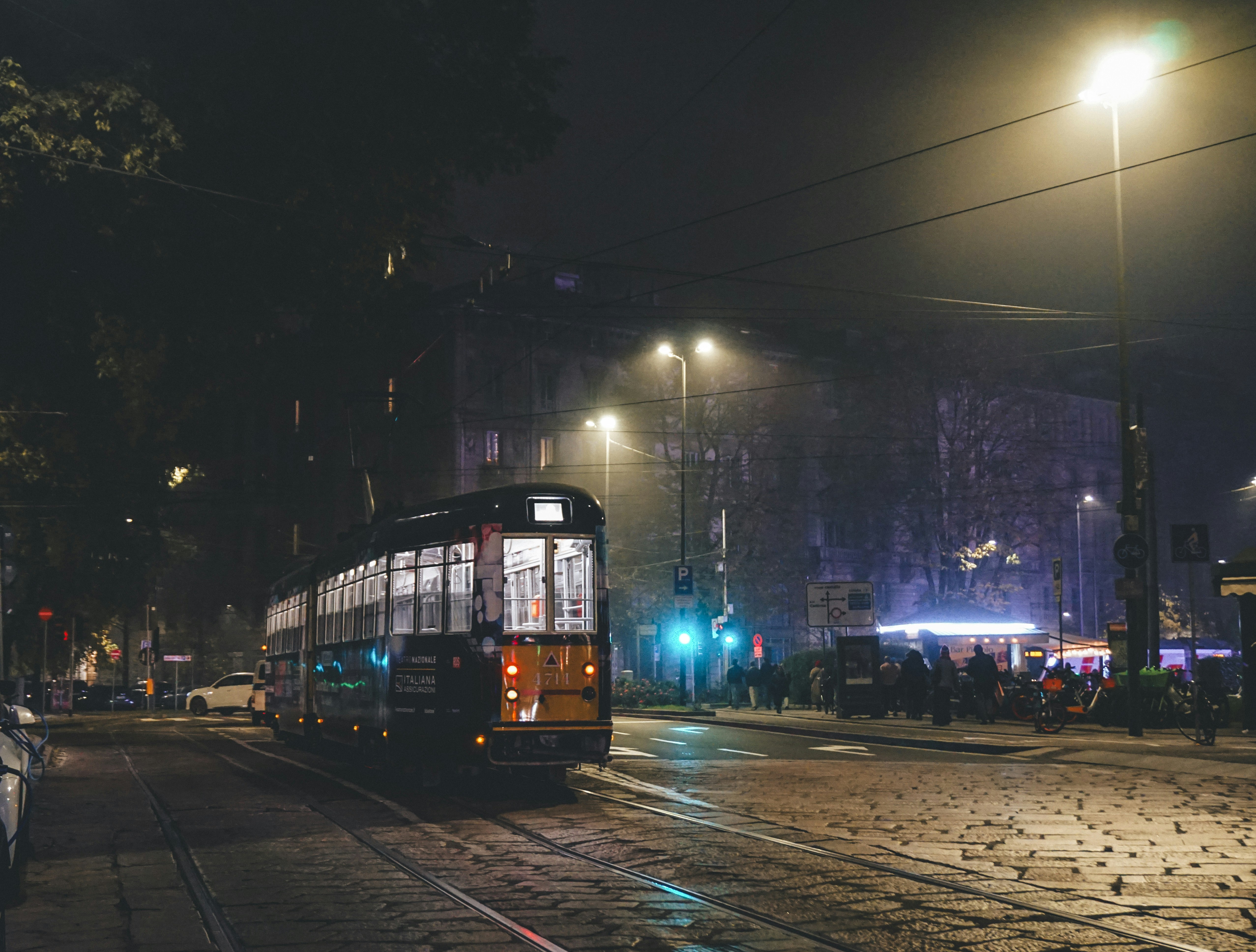 A bus driving down a street at night