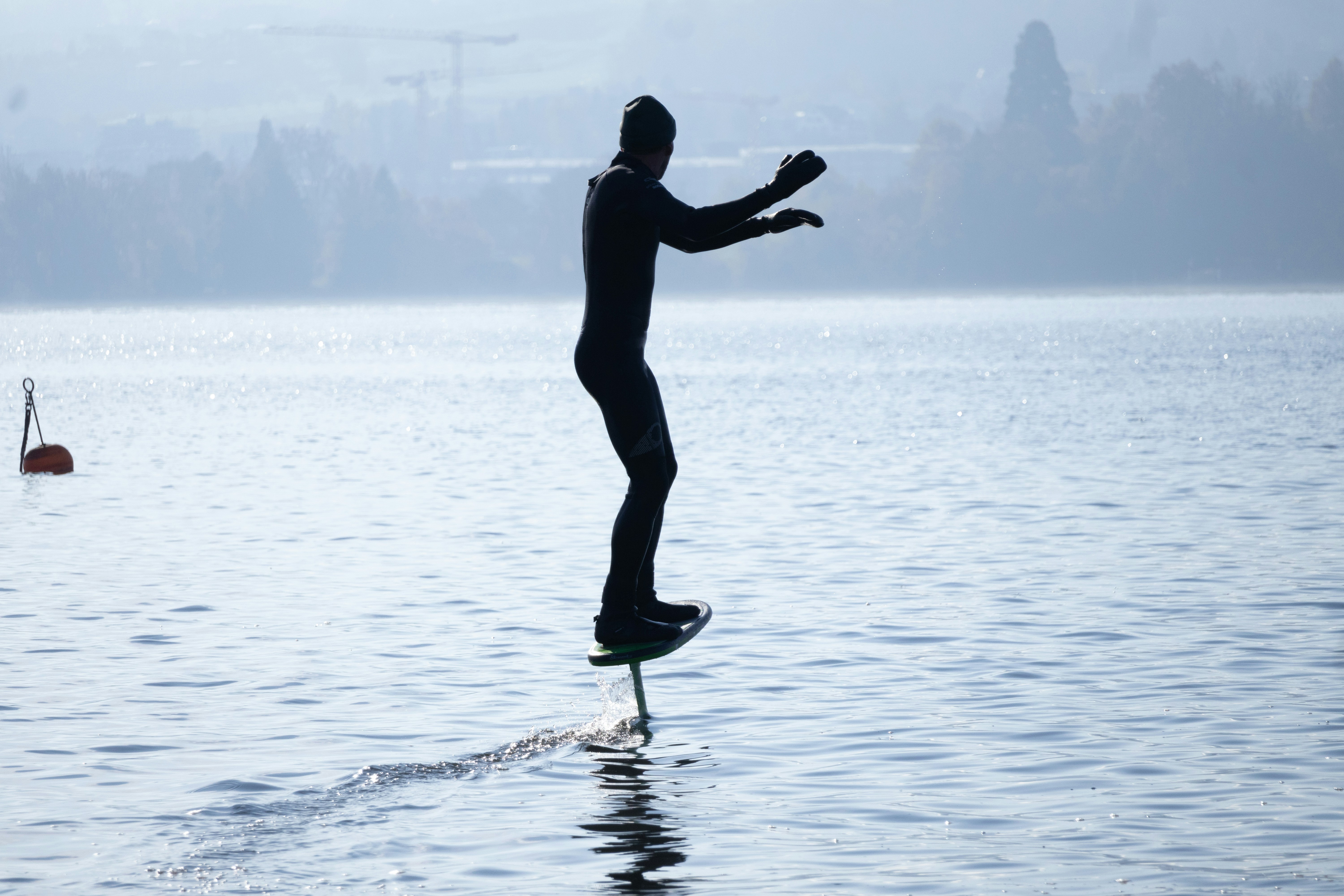 A person standing on a surfboard in the water