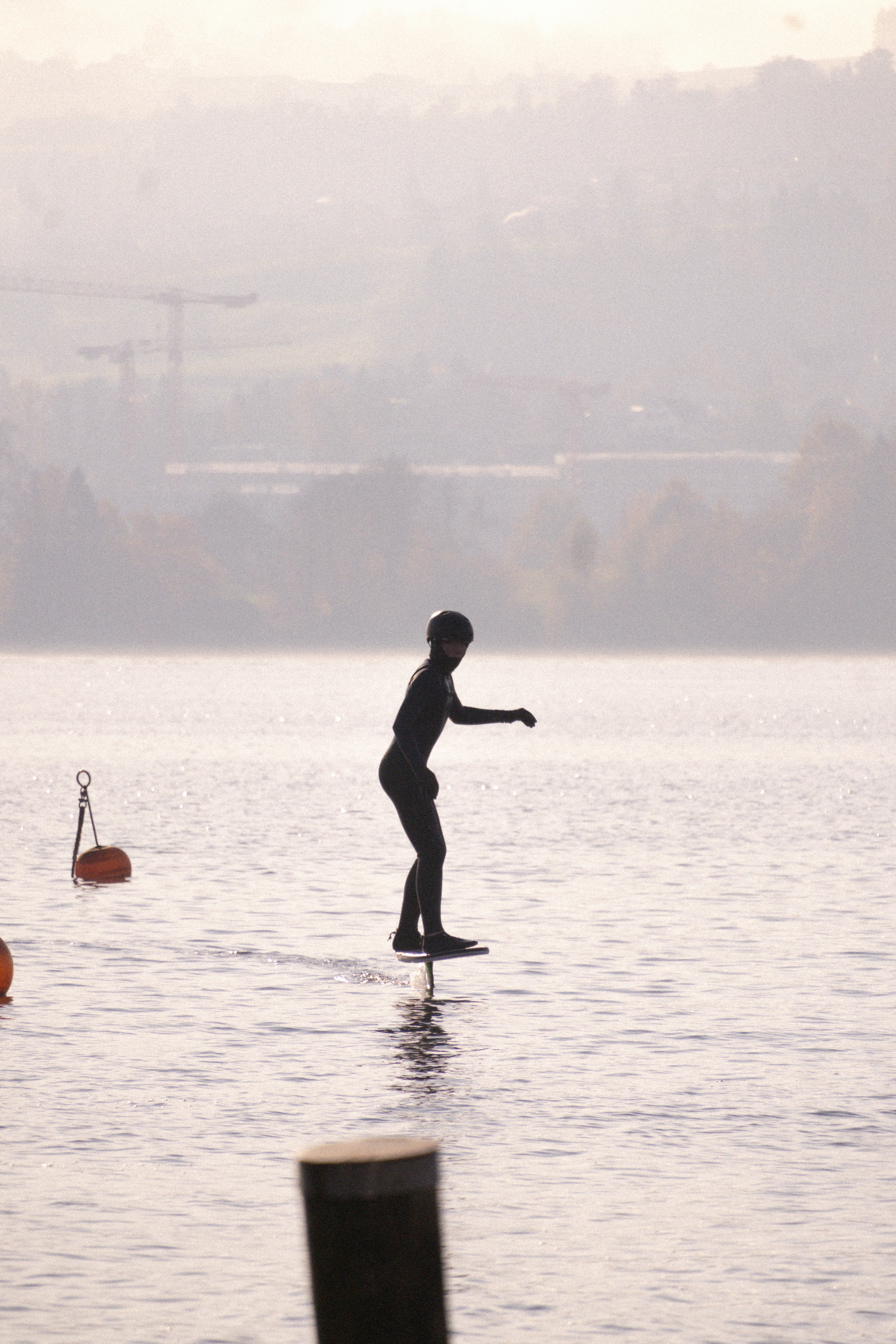 A person standing on a surfboard in the water