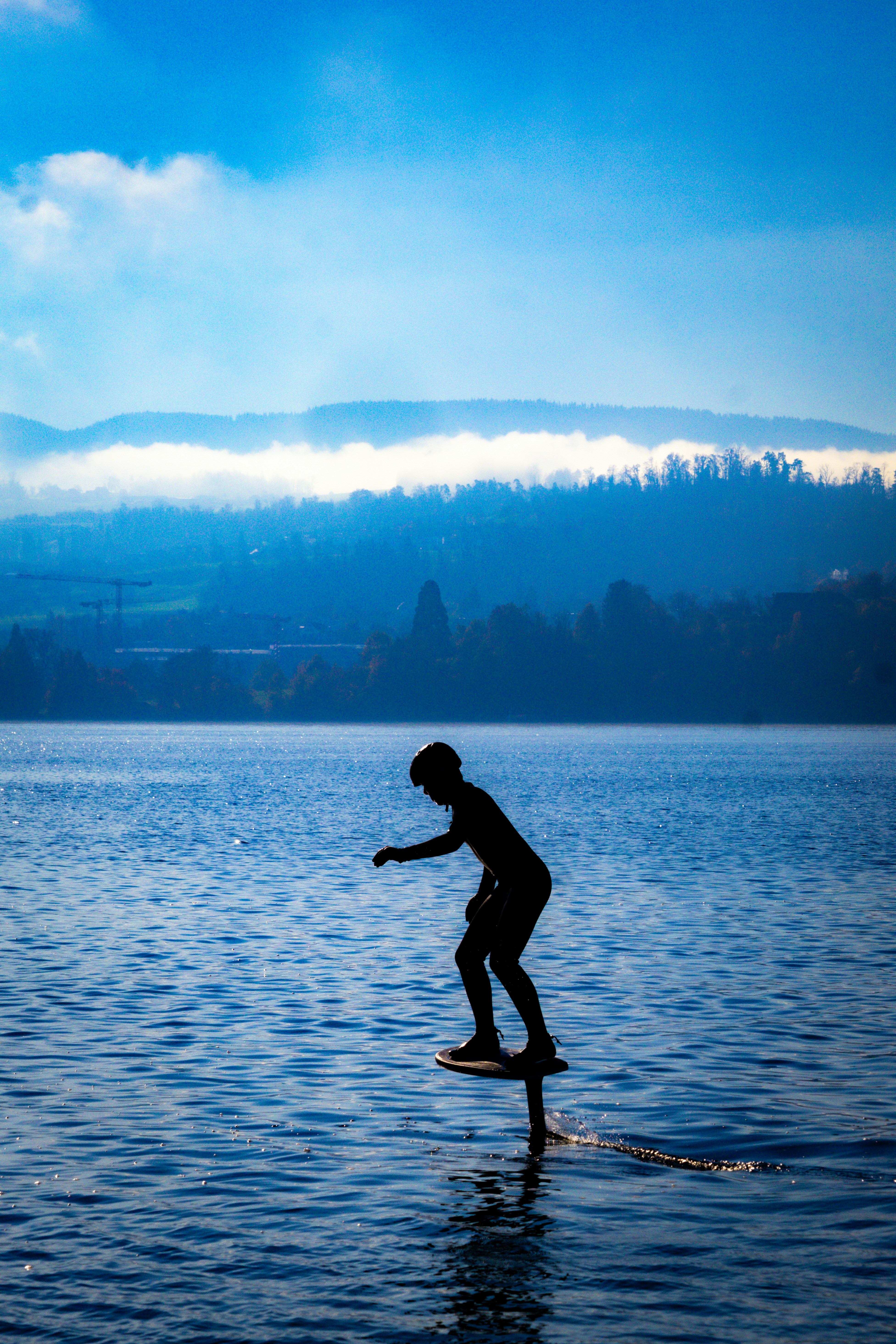 A person riding a surf board on a body of water