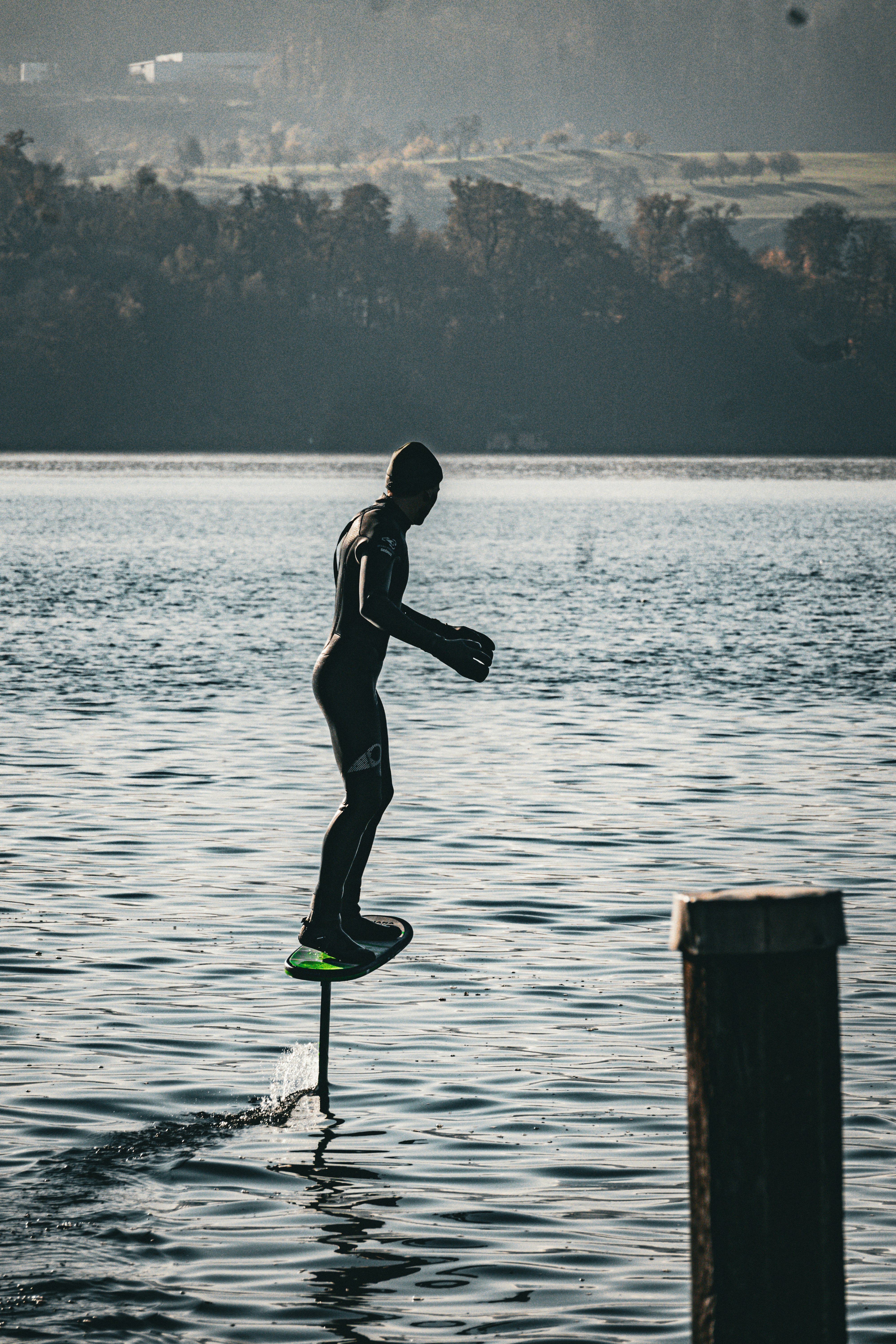 A man riding a surfboard on top of a body of water