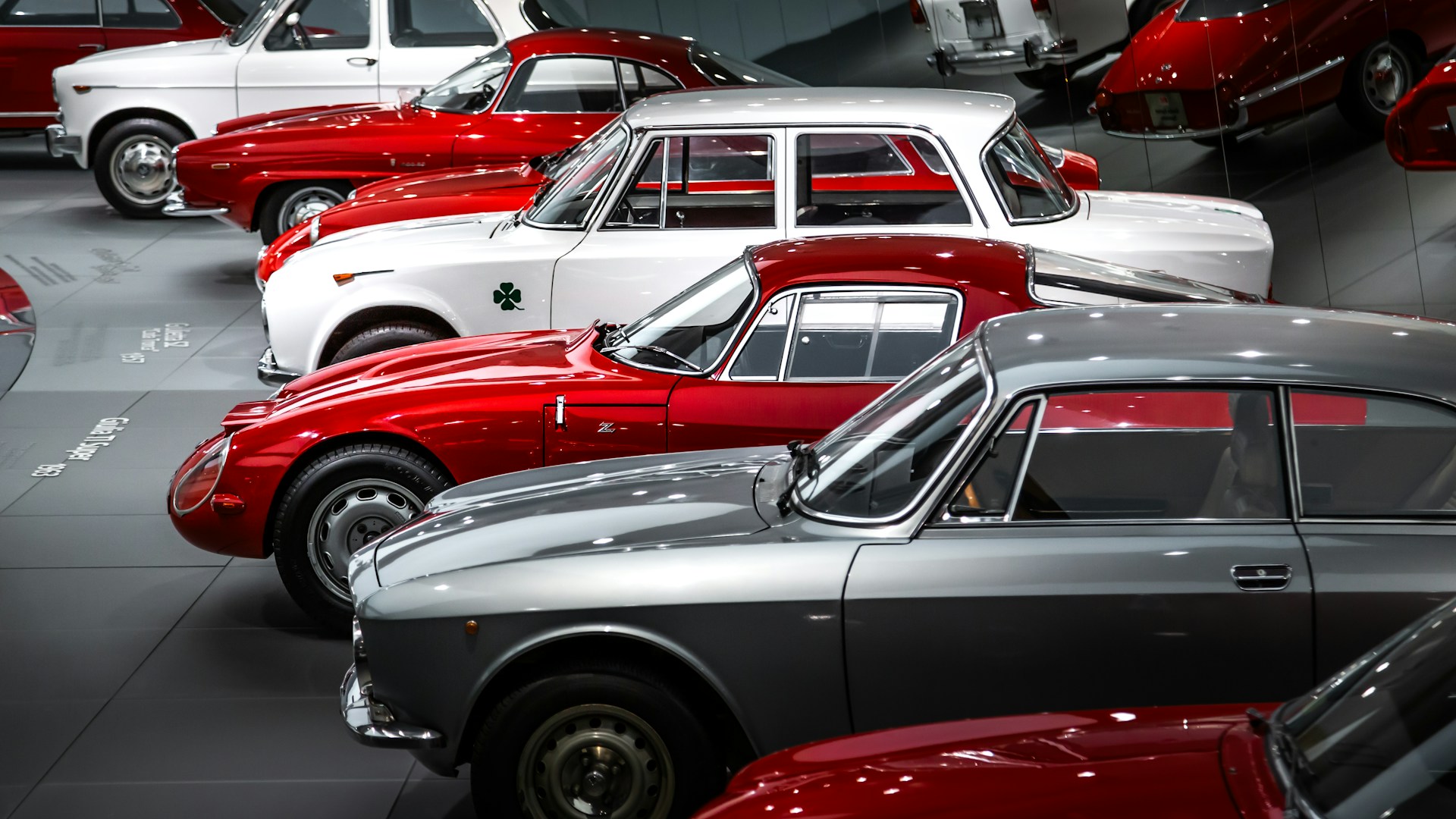 A bunch of cars are parked in a garage