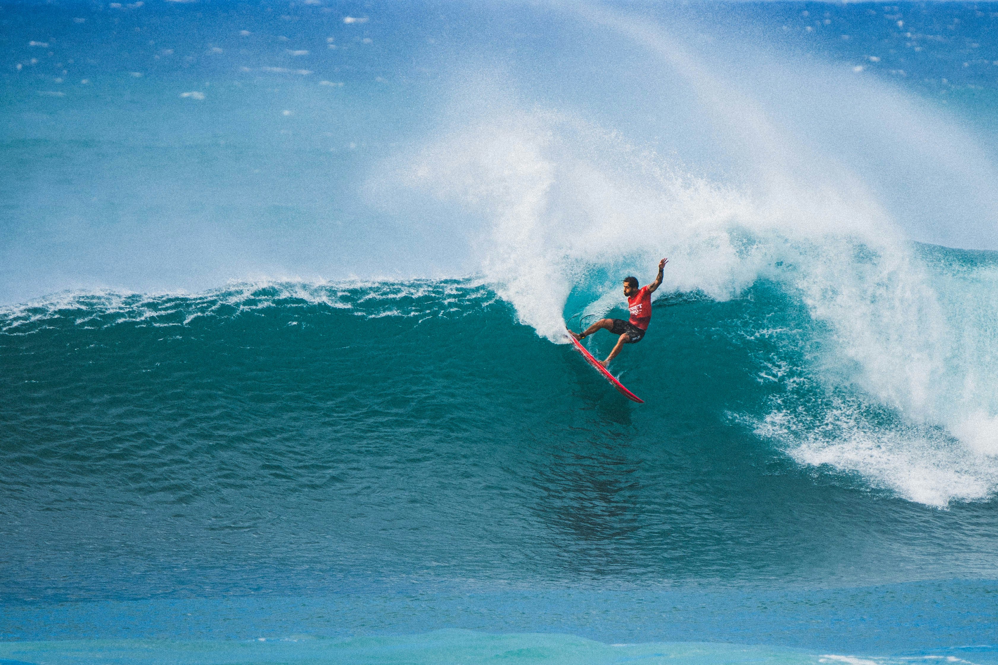 A man riding a wave on top of a surfboard