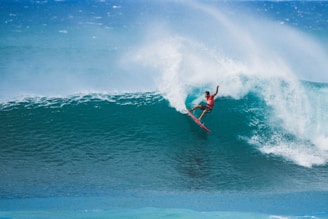 A man riding a wave on top of a surfboard