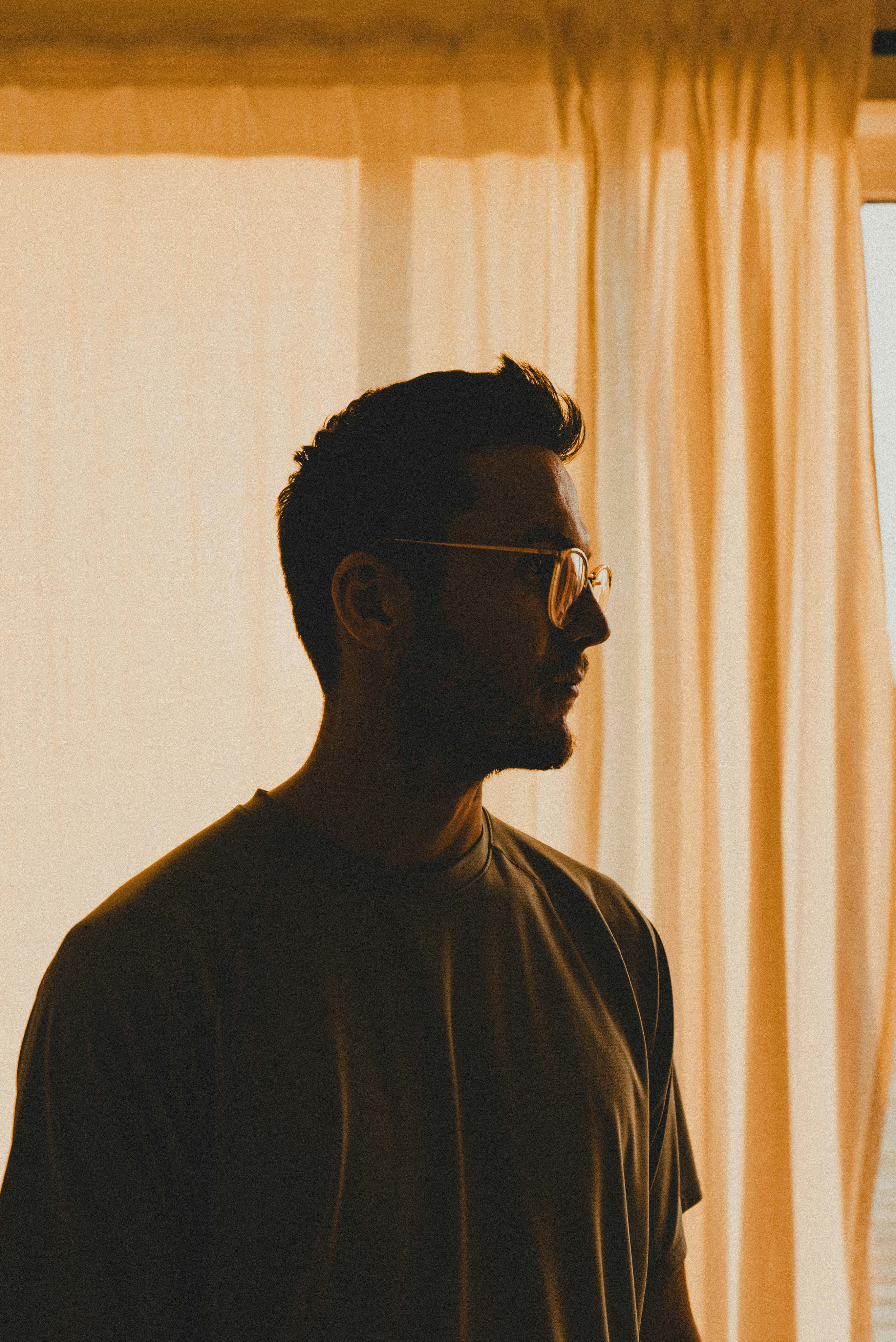 A man standing in front of a window