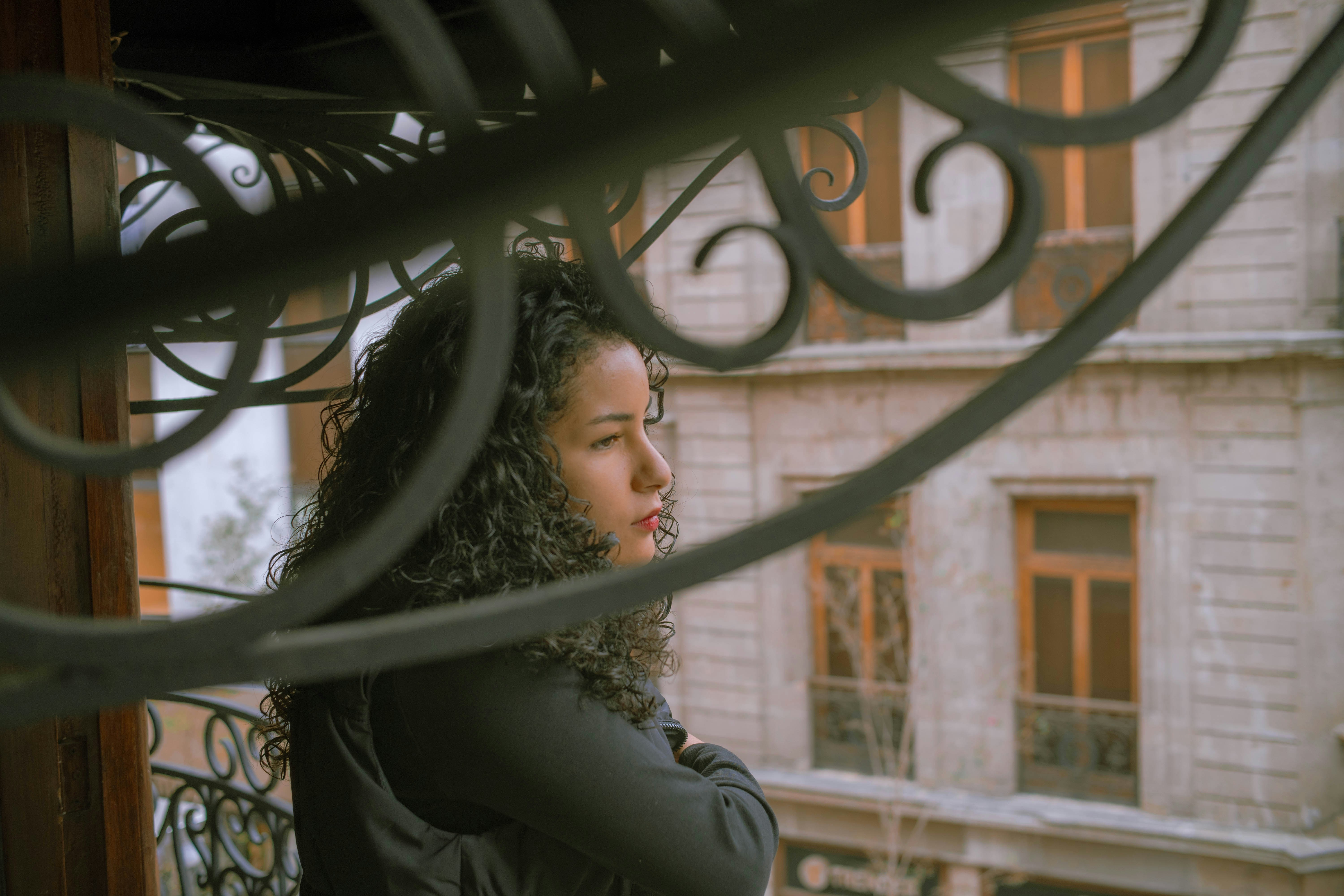 A woman looking out a window at a building