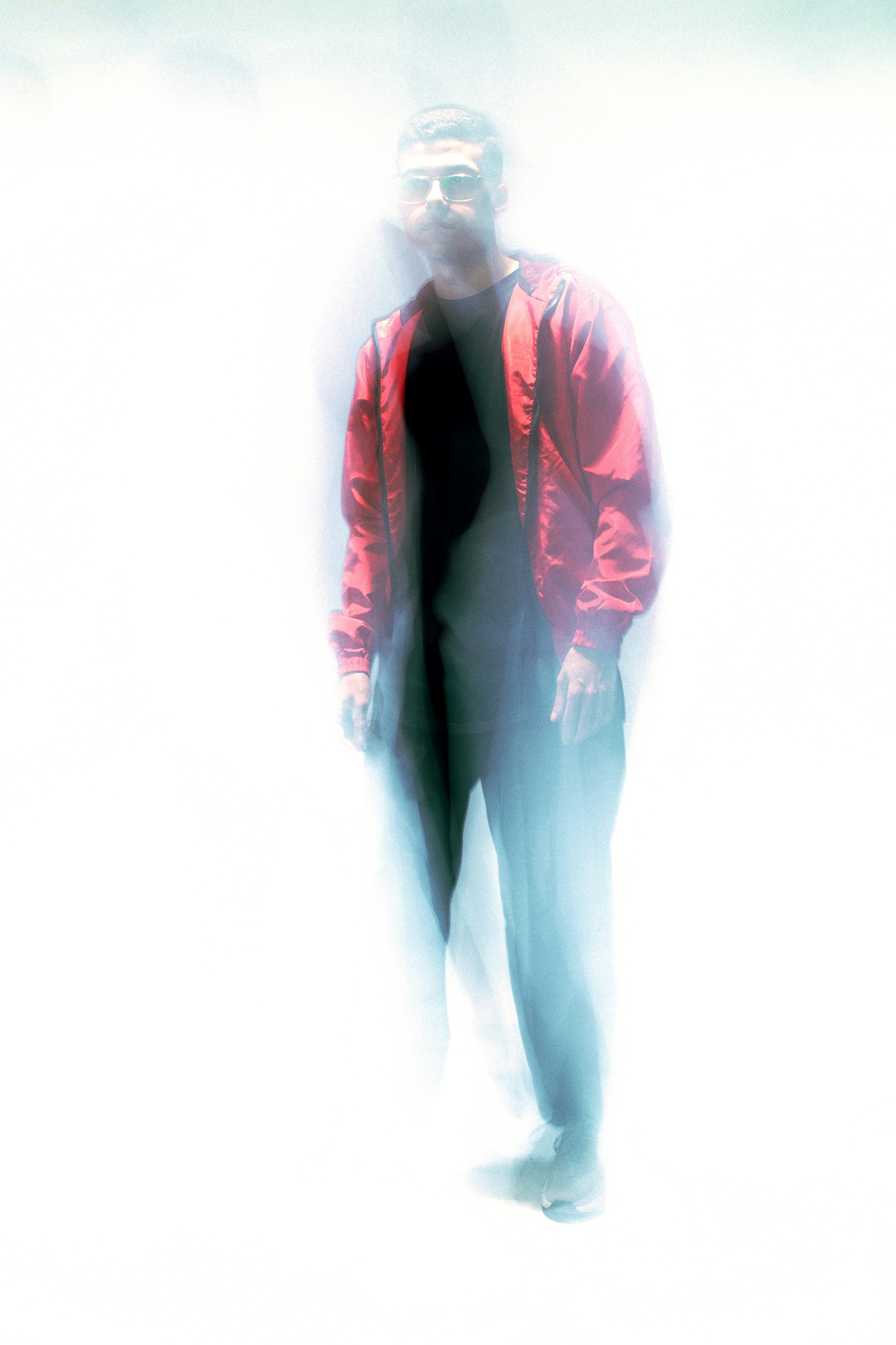 A blurry image of a man in a red jacket