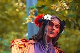 A man in a costume with flowers in his hair