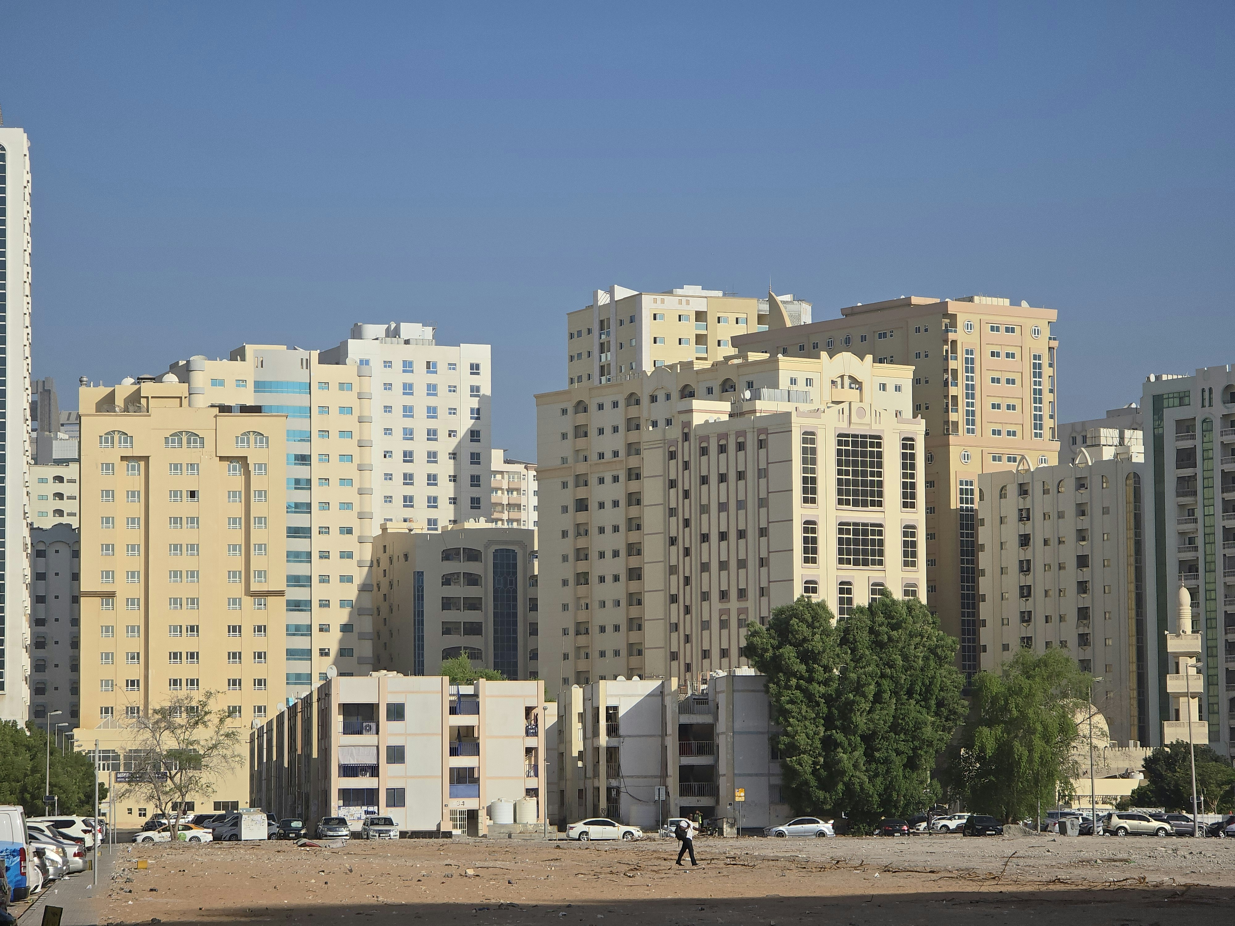 A city with tall buildings and a sandy beach