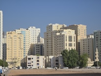A city with tall buildings and a sandy beach